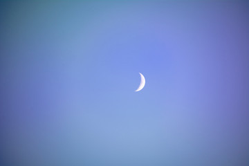 Crescent moon isolated on blue night background.