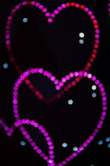 A background image of many hearts created by LED lights and the Bokeh effect.