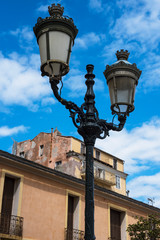 Fototapeta na wymiar Typical old street light of the corsican Bastia city with colorful buildings on the background during summer day. France 2019.