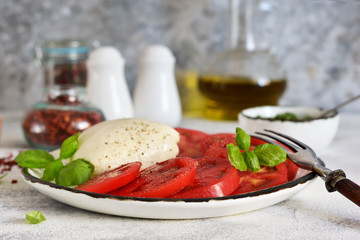 Caprese is a classic Italian snack with mozzarella, tomatoes and olive oil.