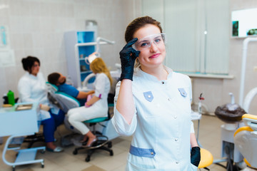 Dental clinic. Portrait of a professional dentist on the background of a working team of doctors....