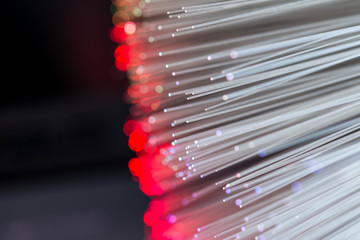 Glowing colorful optical fibres over laptop computer keyboard , image for background.