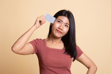 Young Asian woman think with a blank card.