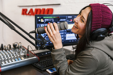 Cheerful young woman radio host broadcasting