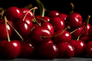selective focus of red delicious and ripe cherries