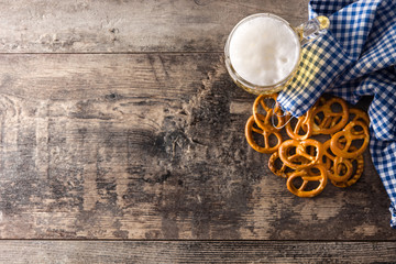 Oktoberfest beer with pretzels on wooden table.Top view.  Copyspace