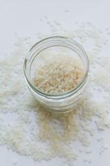 Pile of raw white rice in jar , macro 