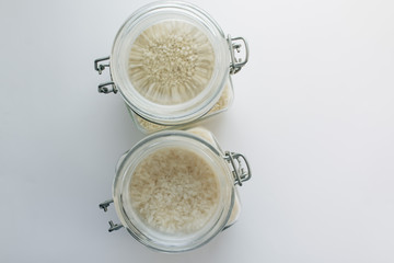 Pile of raw white rice in jar , macro 