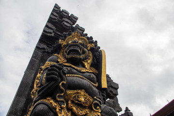 Fototapeta na wymiar Indonesia god statue in front of bali temple.Traditional indonesian hindu symbol in ubud,Bali,Indonesia