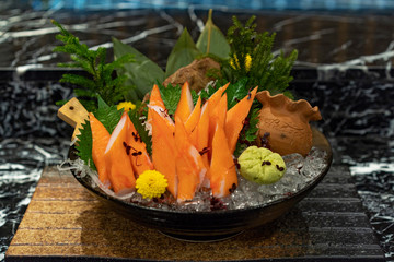 Crab stick in black bowl and ice below. © Surachetsh