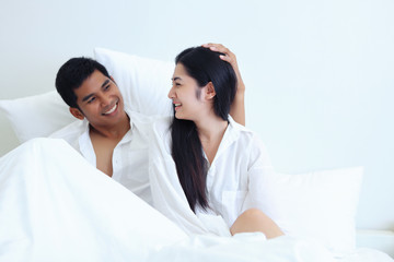 Couples, men and women sitting in bed They are happy