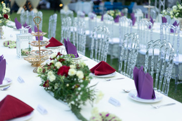 Luxury White - Purple - Red Dinner table set with Crystal chair in the garden.