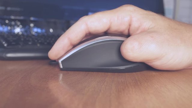 A person with amputated fingers working on a computer. Disability closeup.