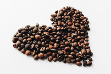 Close-up view of roasted coffee beans and glass cup 