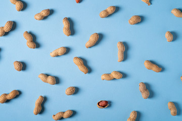 Peanuts flat lay minimal on blue background backdrop food nut texture copy space top view