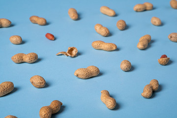 Peanuts flat lay minimal on blue background backdrop food nut texture copy space selective focus angle view 