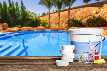 Fototapeta na wymiar Equipment with chemical cleaning products and tools for the maintenance of the swimming pool.