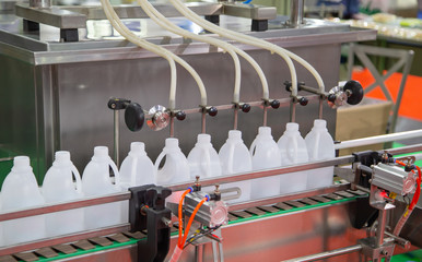 Production of liquid filling in plastic jar on machine. Food industry