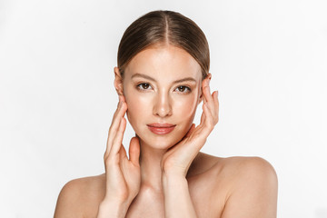 Image of charming half-naked woman looking at camera and touching her face