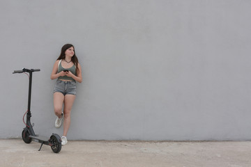 Teenage girl circulating with an electric scooter © expressiovisual