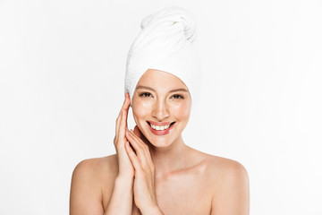 Image of alluring half-naked woman wrapped in towel smiling after shower with hands at face