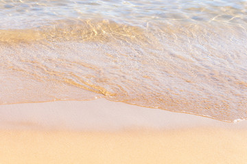 Clear soft wave of sea or ocean on sandy beach. Background.