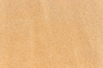 Naklejka na ściany i meble Sand background texture. Brown sand. Top view.