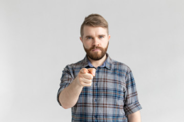 Fototapeta premium Serious student man showing on the camera on white background