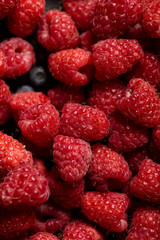 close up view of delicious ripe mixed raspberries and blueberries