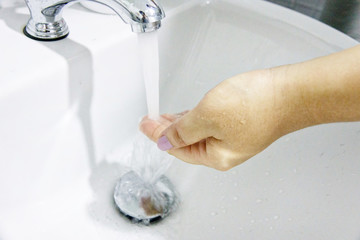 Fototapeta premium Hygiene concept. Washing hands with soap under the faucet with water
