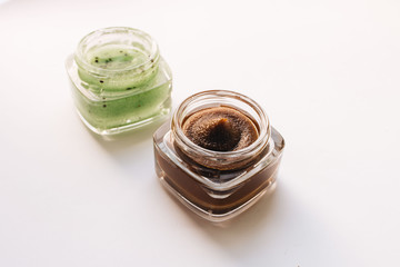 Chocolate cream in small jar on white background
