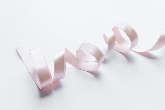 Light Pink Ribbon Decoration On White Background