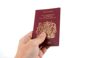hand holding a UK passport