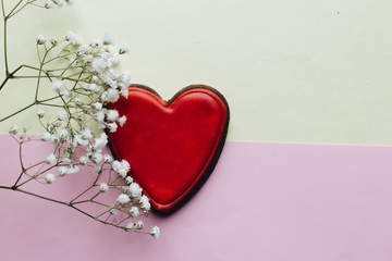 Cookie in heart shape with red glaze and white flowers , valentines day concept, love heart