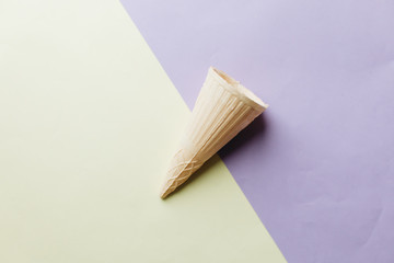 Fototapeta premium Crispy waffle cone on light background