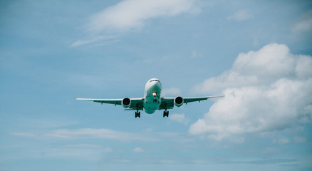 Passenger plane flies in the blue sky.