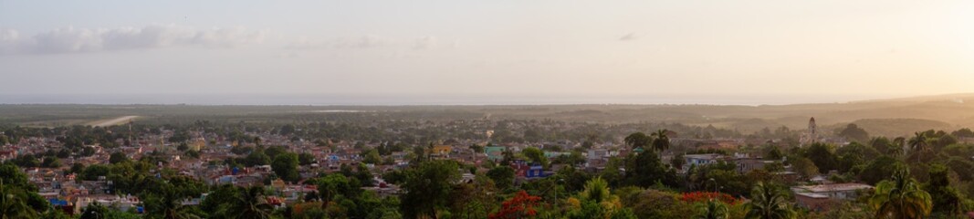 Aerial panoramic view of a small touristic Cuban Town during a colorful and cloudy sunset. Taken in Trinidad, Cuba.