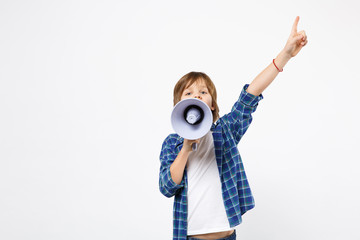 Fun little kid boy in blue t-shirt hold scream in megaphone, announces discounts sale isolated on...