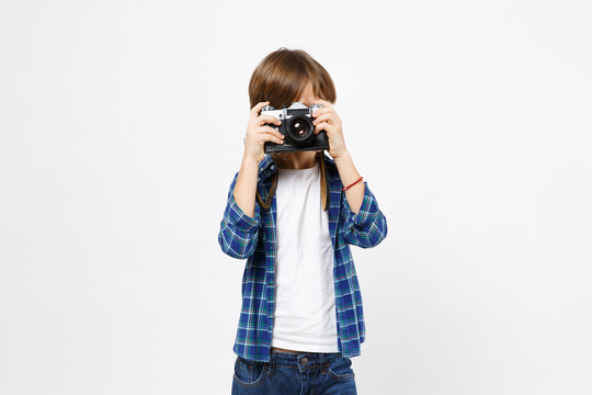 Fun little kid boy in blue t-shirt hold retro vintage photo camera, doing photo shot isolated on white wall background children studio portrait. People childhood lifestyle concept. Mock up copy space.
