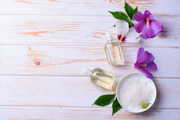 Beautiful layout of cosmetic oils on a wooden background. Natural cosmetics for face and body