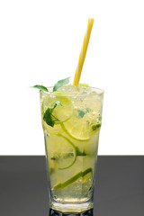 Cooling lemonade with lemon and lime, slices of ginger and mint leaves.