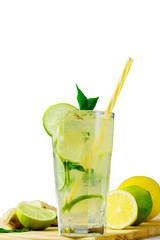 Cooling lemonade with lemon and lime, slices of ginger and mint leaves.