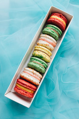 Box with delicious bright macaroons, sweet dessert