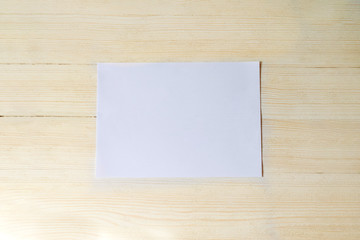 the white piece in the center on a beige wood background