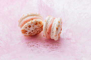 Composition of delicious macaroons on pink background