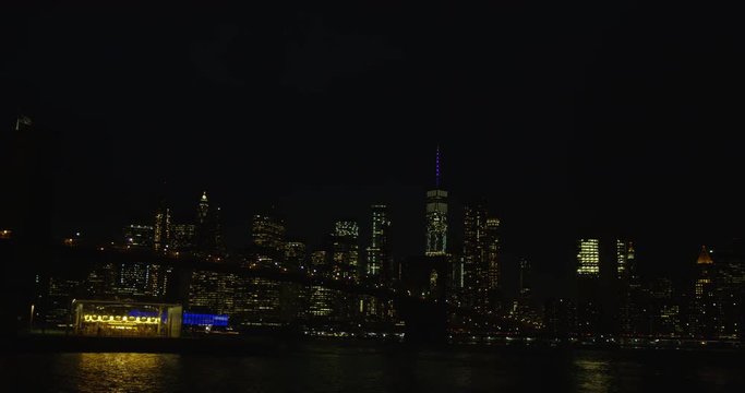 Impressive Shot of Famous Iconic New York Skyline And Brooklyn Bridge At Night With The Infamous Empire State Building In New York