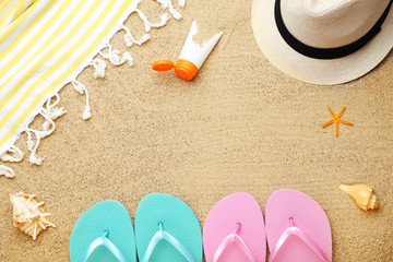 Fototapeta na wymiar Beach clothing with seashells and moisturizer cream on sand