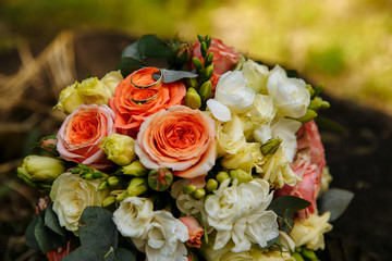 Wedding bouquet and newlyweds rings