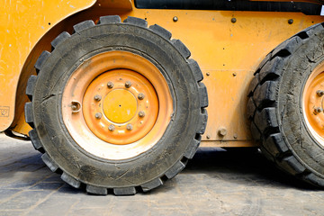 A rear tyre, heavy duty construction site diesel excavator.