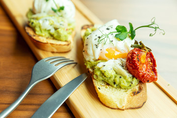 Sandwich with poached egg. Beautifully decorated breakfast. Close-up.